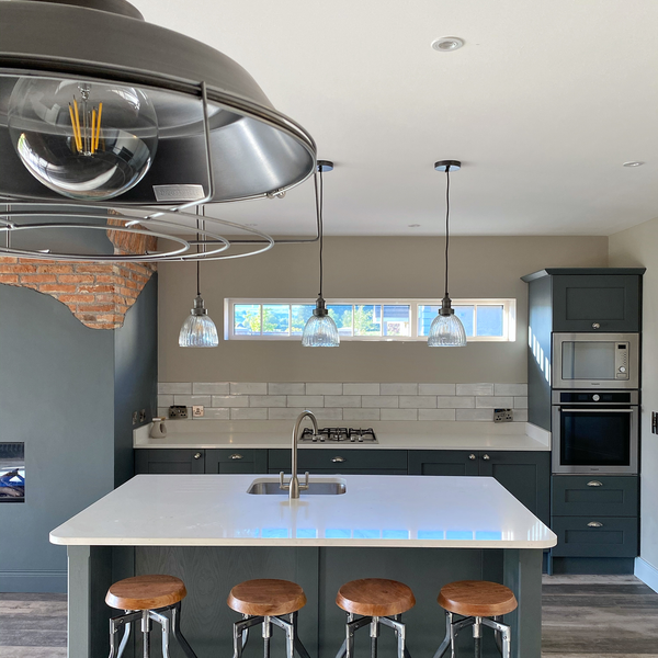 An industrial style kitchen with pendant lights