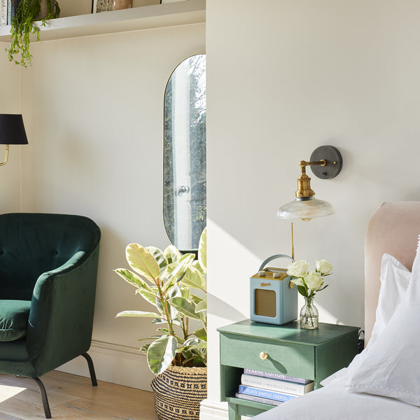 A bright bedroom decorated with light tropical colours