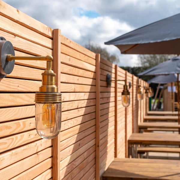 A fence with Industville outdoor lights on it 