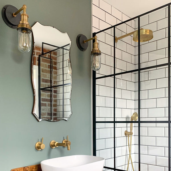 A sink and shower in a stylish bathroom