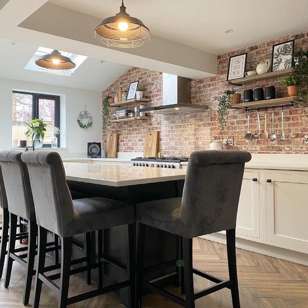 An industrial kitchen with luxury island chairs