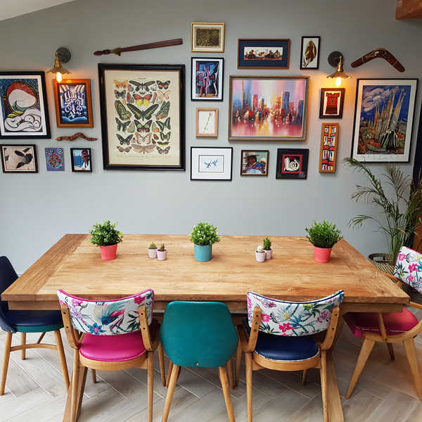 A dining room decorated with vibrant artwork