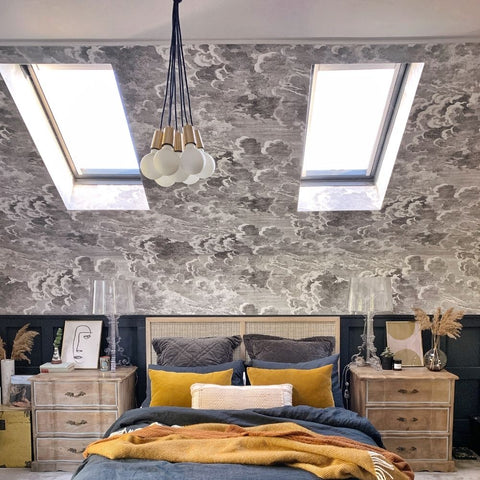 A rustic bedroom interior with hanging pendant lights by Industville