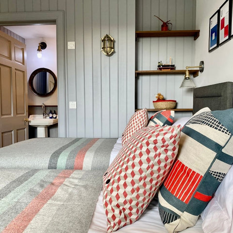 A nautical bedroom interior with bulkhead wall lights by Industville