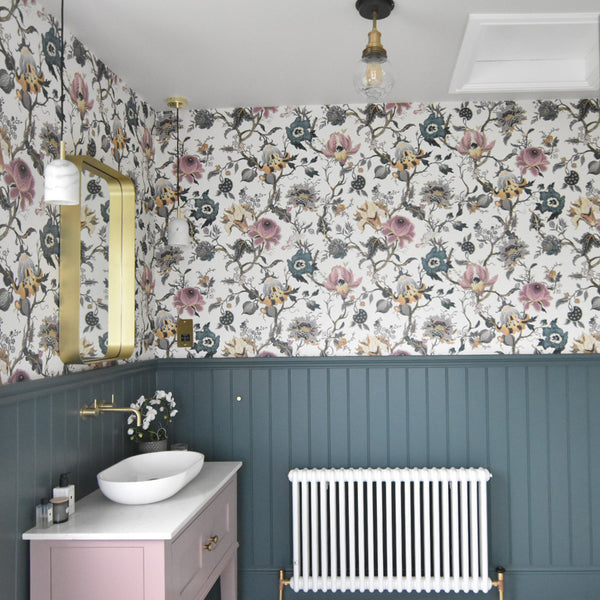 Bathroom with vintage wallpaper and industrial lights