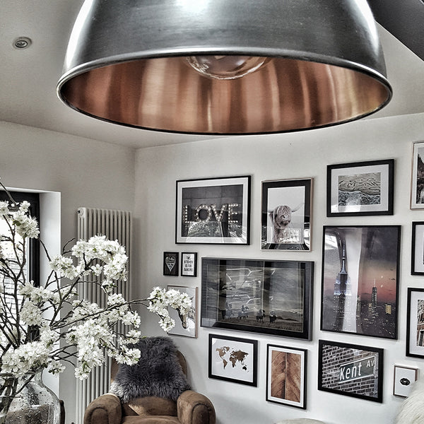 A warm Scandinavian-style living room with industrial-style lighting