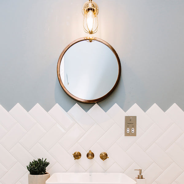 Blue bathroom interior with brass wall light