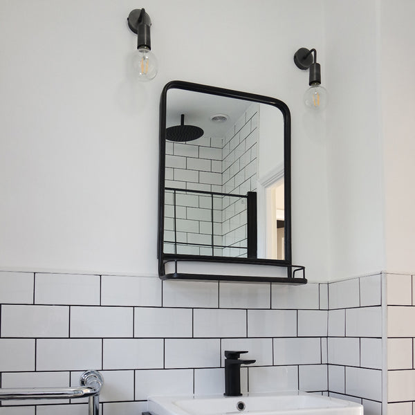 Rectangular mirror with white tiling in bathroom