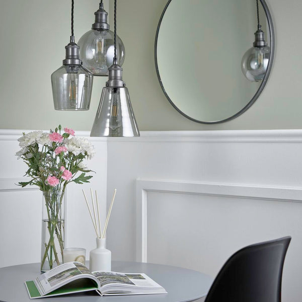 A traditional dining room with hanging glass cluster lighting