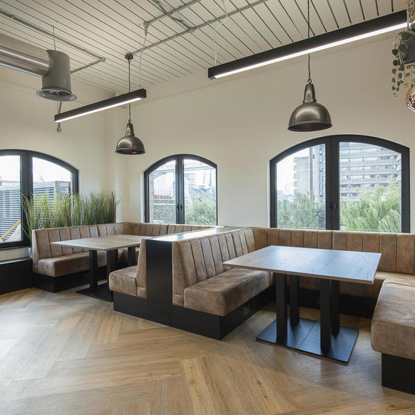 Two large industrial pendants over office booths