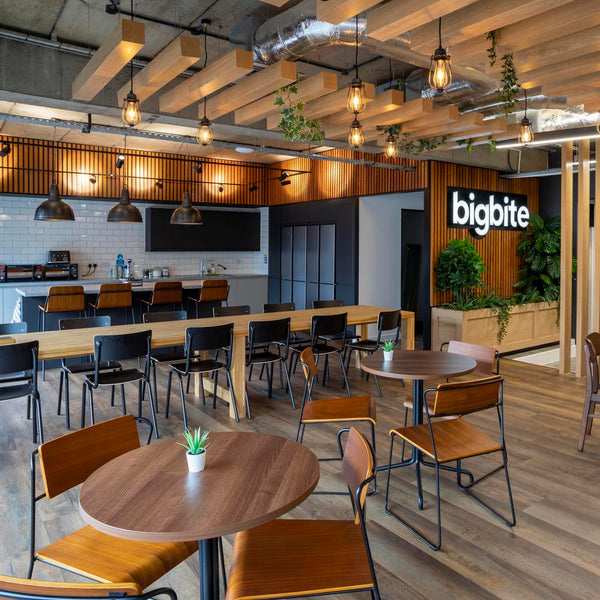 A business cafeteria with wooden features and industrial lighting