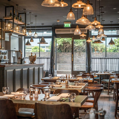 Hanging glass lights by Industville in a restaurant