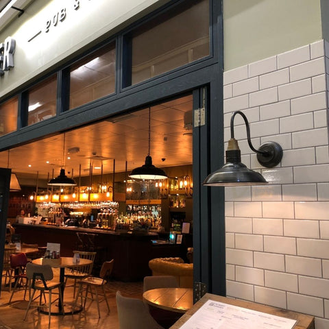 A restaurant with display menu illuminated by a metal wall light by Industville