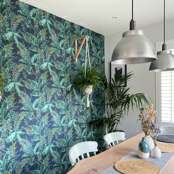 Green, leaf print wallpaper in a dining room