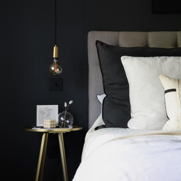 A modern bedroom with black walls