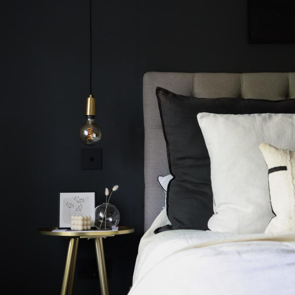 black bed with hanging light