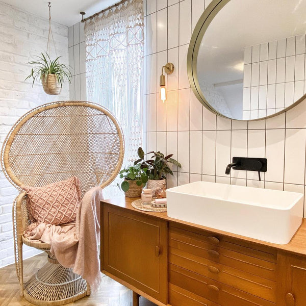 A bathroom sink area with brick and tiled walls