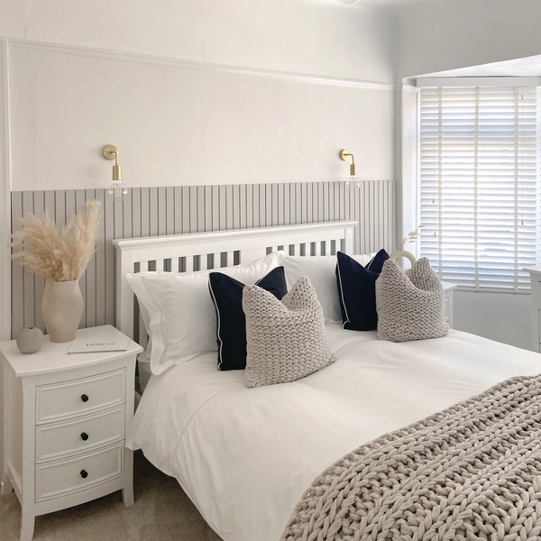 A bedroom decorated in whites and pale greys
