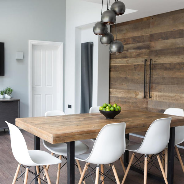 An industrial globe cluster light installed over a dining table