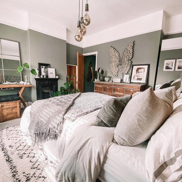 A bedroom with hanging industrial style lights