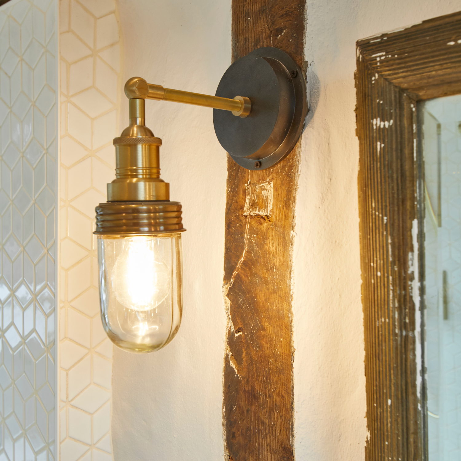 A Brooklyn bathroom wall light in a bathroom with rustic wooden details