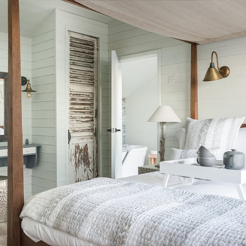 A pale bedroom with wooden pillars