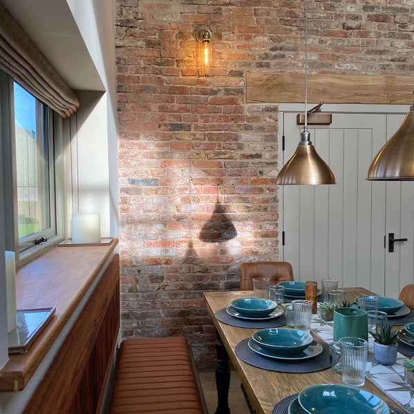 An industrial dining areas with exposed brick wall