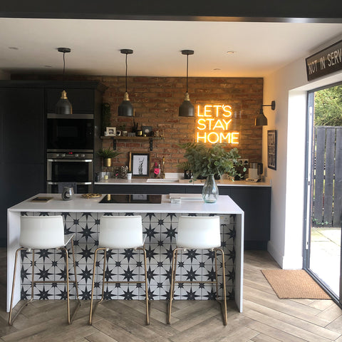 A modern industrial style kitchen with herringbone flooring