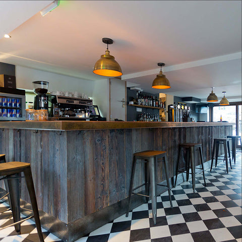 A bar interior with black and white chequered flooring