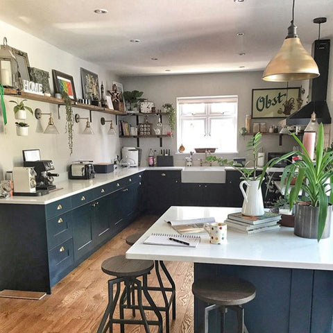 A modern rustic kitchen with dark blue fittings 