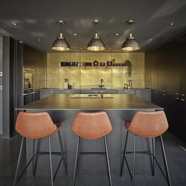 Industrial kitchen interior in a barn conversion with industrial lights