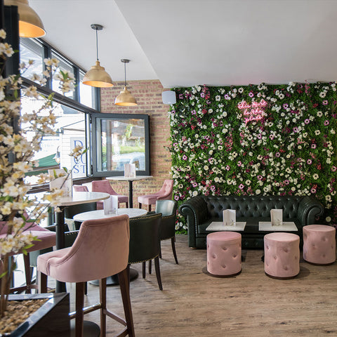 A pink bar with a flower wall feature