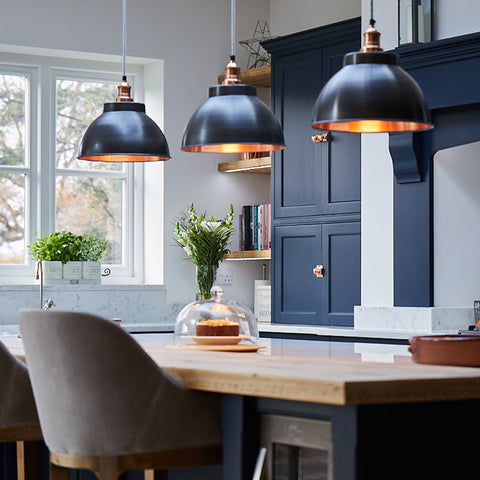 A modern kitchen with statement industrial lighting by Industville