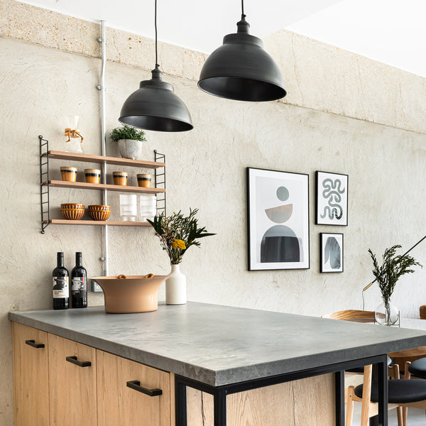 A modern living space with stone walls and metal hanging pendants