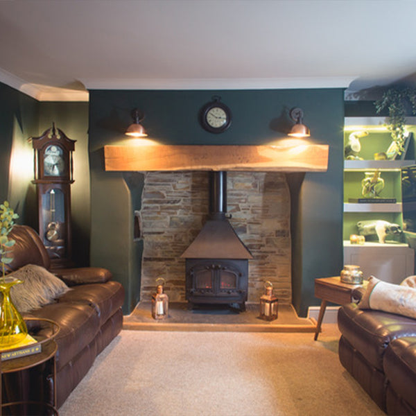 A traditional living room interior with wood burner and industrial lighting