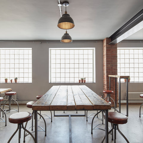 a simple bar interior with wooden and metal table and seats