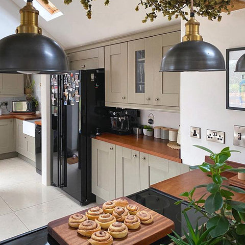 A stylish kitchen with a board of cinnamon rolls