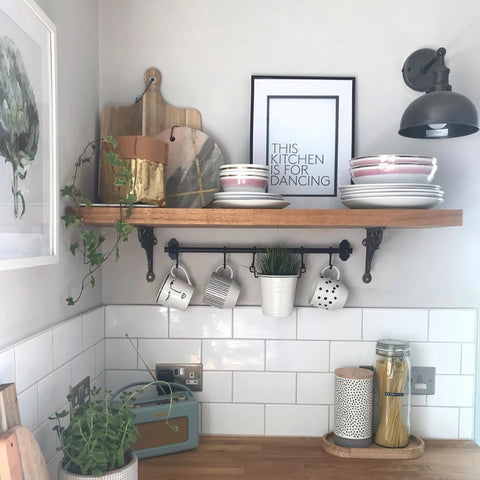 A small kitchen with wooden tabletop and plants