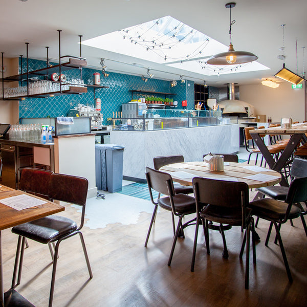 A retro industrial interior with metal chairs and wooden tables