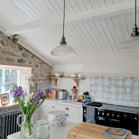 A farmhouse style kitchen with a wooden roof and brick walls