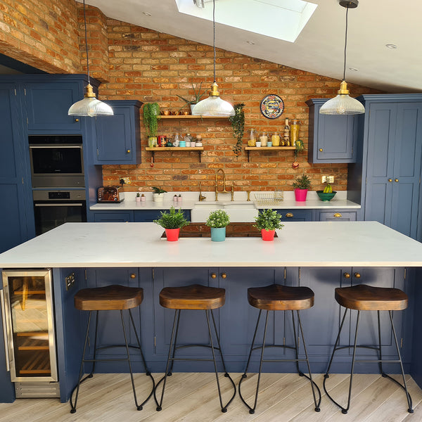 A modern kitchen interior with exposed brick walls