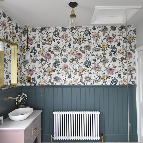 A traditional bathroom with vintage floral print wallpaper