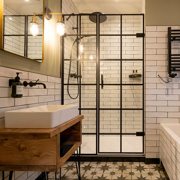 A bright, modern bathroom with industrial lighting