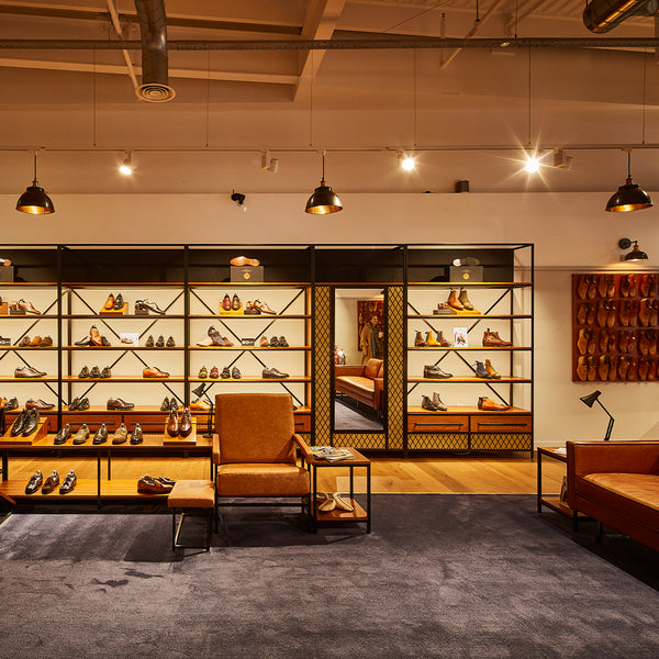 A retail shoe store with wooden features and industrial lighting