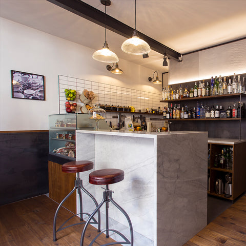 a small wine bar interior with white counter