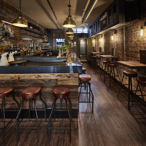 a warm bar interior with wood and brick walls