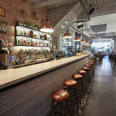 A long, minimalist bar with industrial features