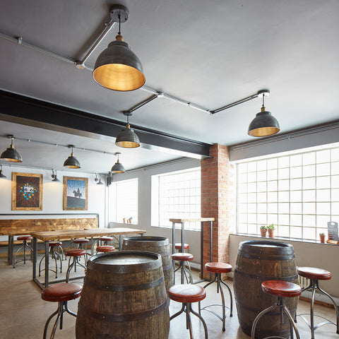 A simple industrial bar interior with barrel tables