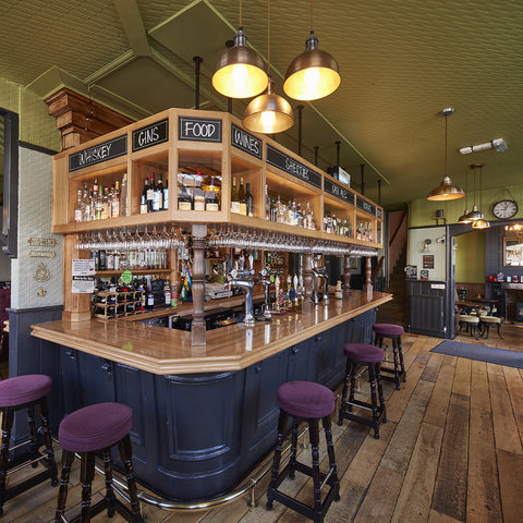 A traditional bar interior with wood and stools