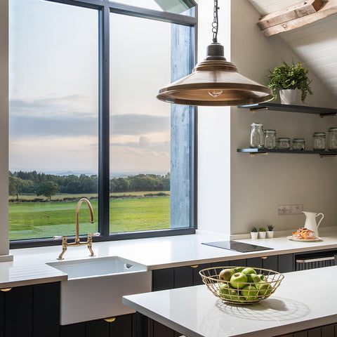 A kitchen with large, feature window